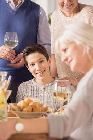 Young boy smiling at happy family dinner