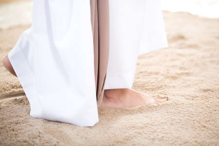 Jesus Christ walking barefoot on the sandの写真素材