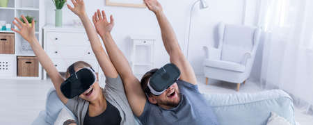 Man and woman watching and having fun with 3D glassesの写真素材
