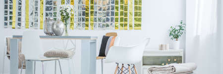 Bright room interior with dining table and chairs