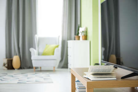 Modern home interior with tv, dresser and armchairの写真素材