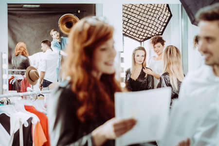 Fashion stylist with professional model on backstage before photo shootの写真素材