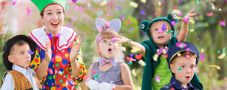 Youth leader celebrating party with childrenの写真素材