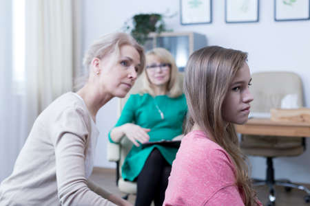 Worried mother looking for communication with her teenage daughterの写真素材