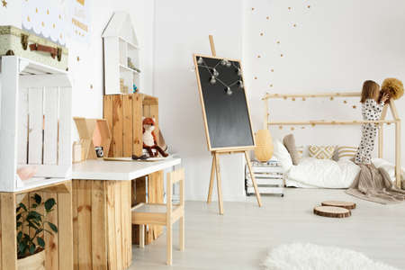 Scandinavian modern interior for girl with wooden desk and accessoriesの写真素材