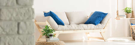 Comfortable white sofa with blue pillows in cozy living roomの写真素材