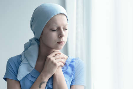 Married woman with cancer faithfully praying for miracle of healingの写真素材