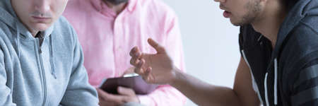 School psychologist leading mediation between troubled teenagersの写真素材