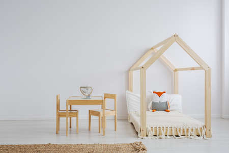 White, simple kid room with wooden furniture setの写真素材