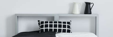 Black and white pillow with geometric pattern on the bed