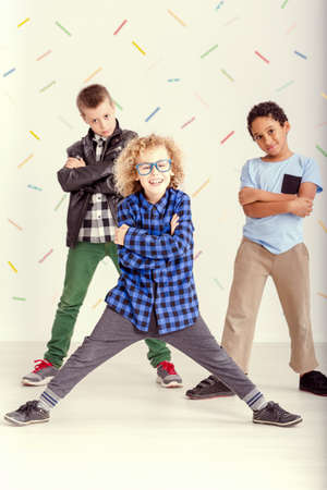 Three young boys standing with crossed arms