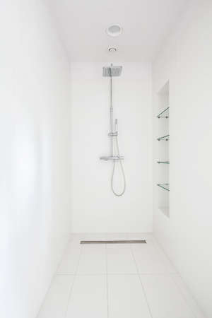 Minimalistic shower in modern bathroom with snowy-white walls,floor and ceilingの写真素材