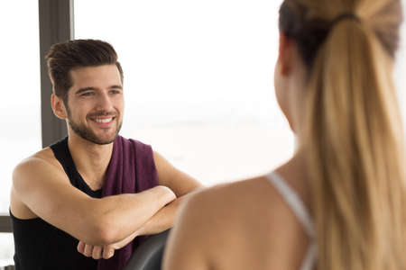 Friends talking during a break on a gym