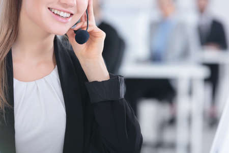 Pretty young woman using microphone at workの写真素材