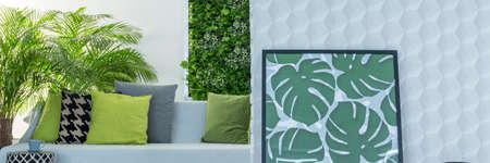 Botanic design of cozy lounge in grey and green colors