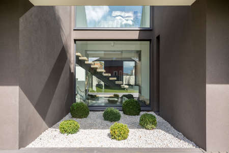 Big window in cubic niche of modern houseの写真素材