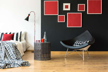 Monochromatic and simple bedroom in red and blackの写真素材