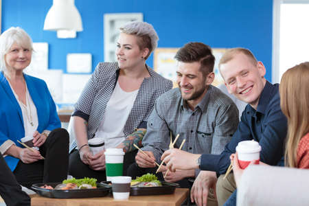 Group of employees having a meal during lunch break in the office