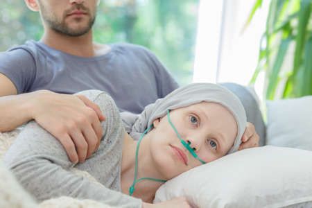 Young sad woman resting with oxygen nasal cannula onの写真素材