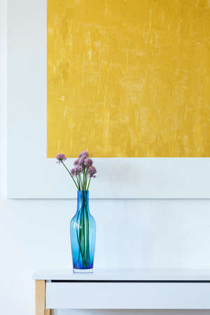 Minimal, yellow, abstract artwork and blue glass flowerpotの写真素材