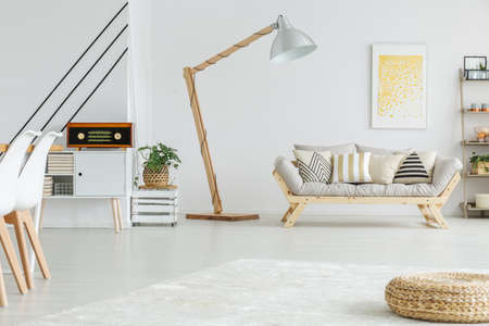 Spacious white living room with geometric pattern on the wallの写真素材