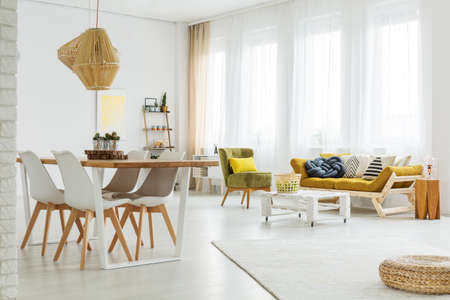 Colorful bright spacious room with wooden modern furnitureの写真素材