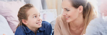 Pretty young happy woman spending mother's day with her teenage daughterの写真素材