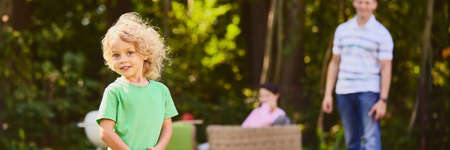 Young boy having fun with parents in the house garden