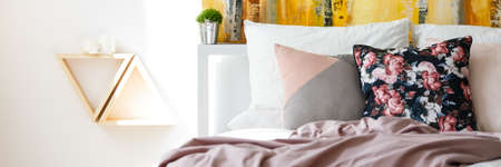 Colorful bedhead and a triangle shaped shelves