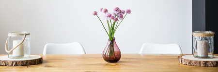 Minimalist vase with pink flowers on the tableの写真素材
