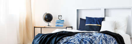 King-size bed in stylish modern bedroom with nightstand