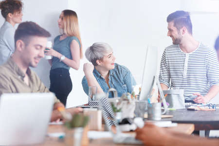 Pair of caucasian employees having a relaxing discussion on a breakの写真素材