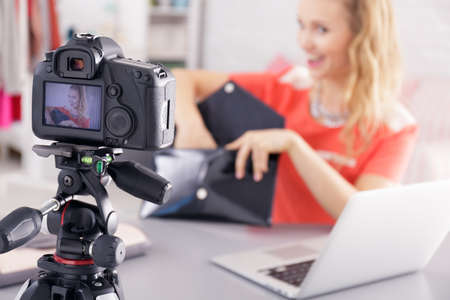 Young woman enjoys making a videoblog about fashion accessoriesの写真素材