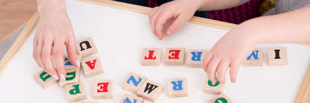 Close-up of speech therapist during reading classes with student