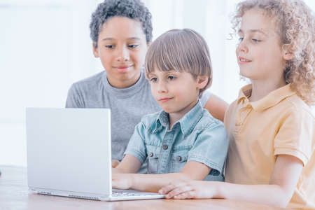 Young boy learns to program the robots during coding classes, children coding concept