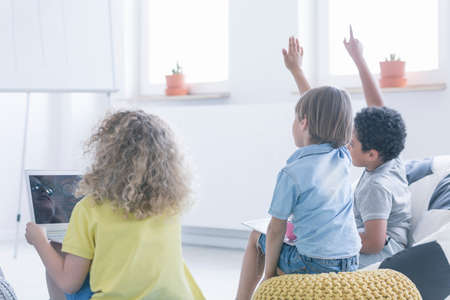 Girl uses laptop during modern coding classes in white classroom, modern school conceptの写真素材