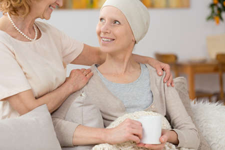 Smiling woman suffering from cancer spending time with her friendの写真素材