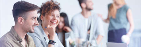 Smiling coworkers during brainstorm in modern officeの写真素材