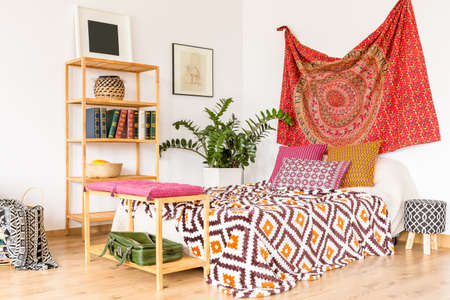 Boho and cozy bedroom in warm oriental colorsの写真素材