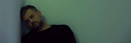 Sad, lonely man overwhelmed with life problems, panoramaの写真素材