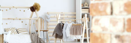 Cozy, scandinavian girl's bedroom with wooden decorationsの写真素材