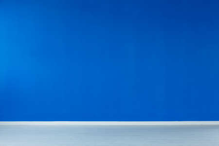 Spacious, empty interior with blue wall, and a blue floorの写真素材