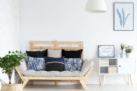 Trendy white lagom living room with simple wooden sofaの写真素材