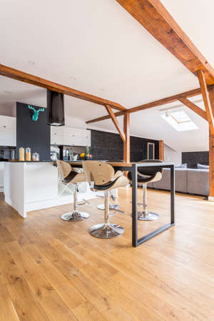 Modern black and white kitchen with blue decor on wall and wooden elementsの写真素材