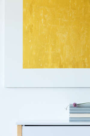 Stylish room interior with contemporary yellow artwork and pastel details