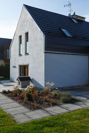 Family house exterior with concrete patio and hidden gutter systemの写真素材