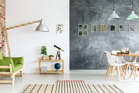 Creative handmade decorations in living room with telescope on small tableの写真素材