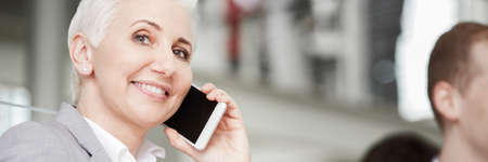 Woman working in big business company, talking on phone, panorama