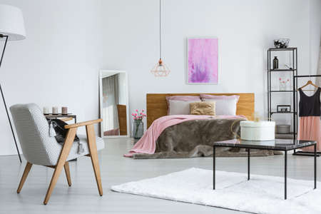 Double bed with fur blanket and pillows in an apartment for a chic womanの写真素材