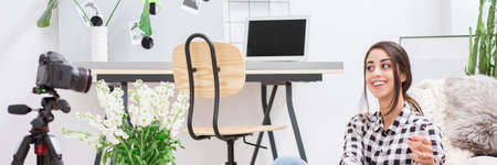 Successful woman using camera to communicate online with business partners